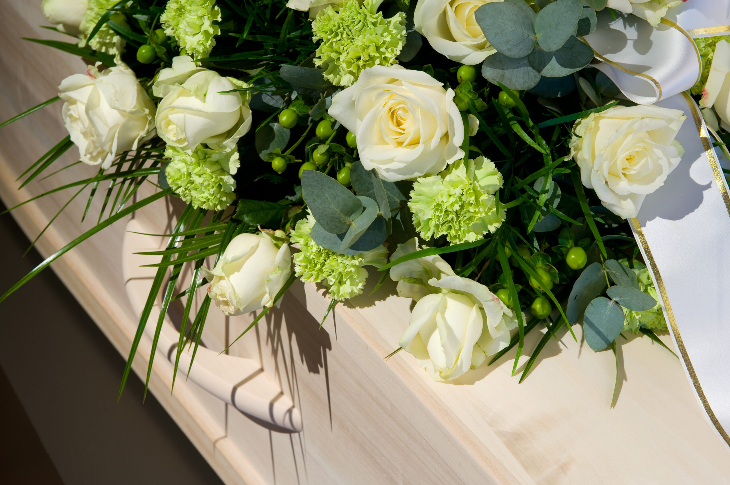 A,Coffin,With,A,Flower,Arrangement,In,A,Morgue